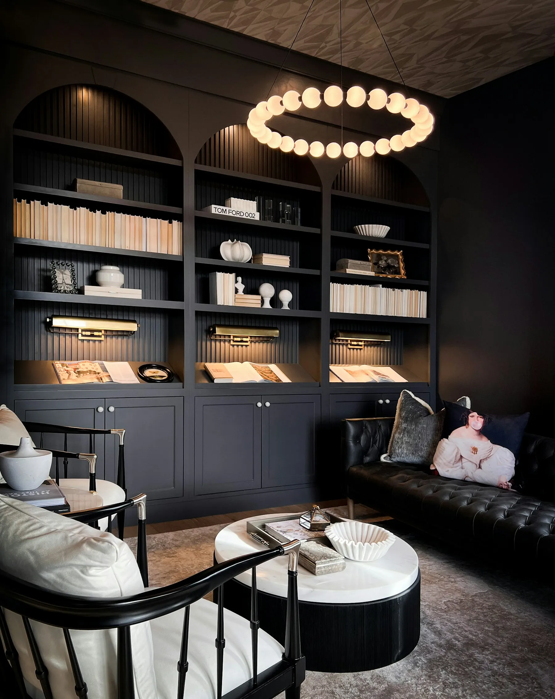 Warmly lit private library with dark shelving